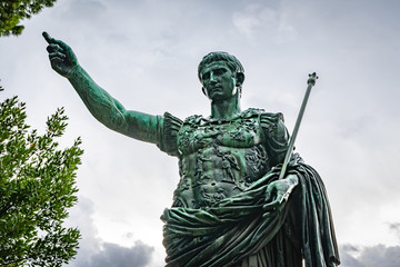 Rome, Italy. Bronze statue of Roman Emperor Augustus Caesar on Via dei Fori Imperiali street in the city. Inscription: SPQR IMP CAESARI NERVAE F TRAIANO OPTIMO PRINCIPI. ANNO XI A FASCIBVS RENOVATIS.