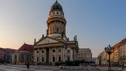 Fototapeta na wymiar Berlin, Germany - March 28, 2020 - French Cathedral located at the Gendarmenmarkt at the Corona crisis - A lonely man