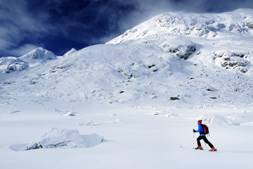 Fototapeta na wymiar Trekking in harsh winter condition. Winter alpine landscape