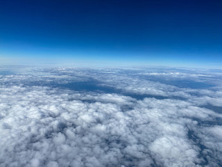 An aerial view of clouds with blue skies.