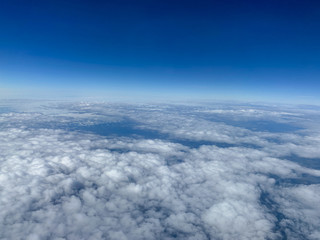 An aerial view of clouds with blue skies.