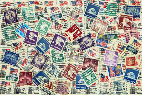 Set of various USA postage stamps as background.