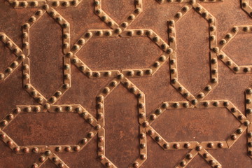 Metal door pattern of Nasrid Palaces (Palacios Nazaries) at the historical Alhambra Palace complex in Granada, Andalusia, Spain.