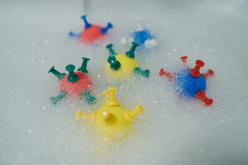 models of coronavirus in soapy washroom water