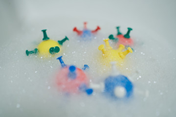 models of coronavirus in soapy washroom water