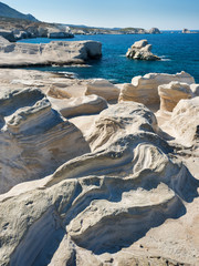 curved formation of stone coast on greek island Mylos © sergejson