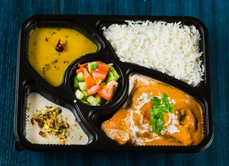 Indian food including curries, rice, samosas and naan bread.