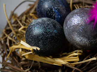 space easter eggs lie in a nest with hay, photo close