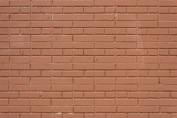 Orange painted brick wall background with alternating running bond and jack bond brick pattern, horizontal aspect