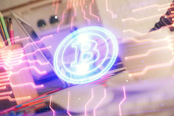 Double exposure of woman hands typing on computer and crypto market theme hologram drawing....