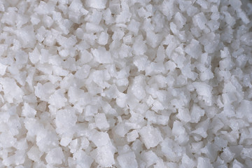 Background of sea salt, grains of salt crystals production. Heap of coarse salt