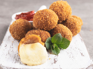 Breaded mozzarella cheese balls with tomato sauce