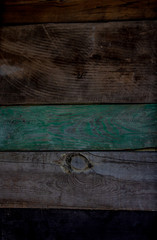 wooden background from several boards of different colors, knocked down in parallel