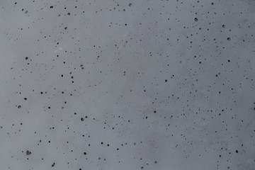 concrete background with small holes like the surface of the moon