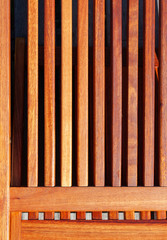 Parallel slats of wood from a wooden deck chair