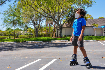 coronavirus kids young boy looking up white sideways mask sick bending standing roller skate falling mask n65 holding roller skate up closeup covid19