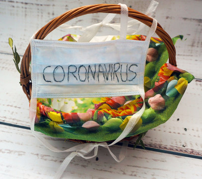 pusy Easter basket with an antiviral mask with the word coronavirus on it