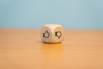 Thumbs up and thumbs down symbols on wooden dice
