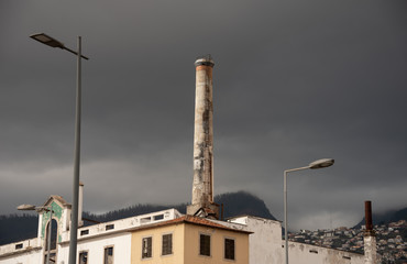 Old, vintage chimney under cloudy sky in Funchal, Madeira. 