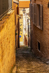 View of a beautiful narrow steep street in Fermo, Province of Fermo, Marche Region, Italy