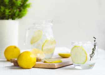 Fototapeta premium Fresh Sweet Lemonade Water; knife, wood and some plants