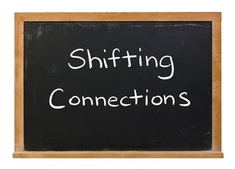 Obraz premium Shifting connections written in white chalk on a black chalkboard isolated on white