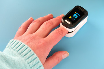 Pulse Oximeter, finger digital device to measure person's oxygen saturation. Reduced oxygenation is...