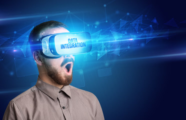 Businessman looking through Virtual Reality glasses with DATA INTEGRATION inscription, cyber security concept
