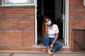 sad woman in quarantine with face mask