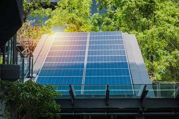 Photovoltaic solar power panels renewable energy installed on modern building rooftop in the city. Eco green clean alternative power energy innovation concept