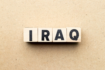 Letter block in word iraq on wood background