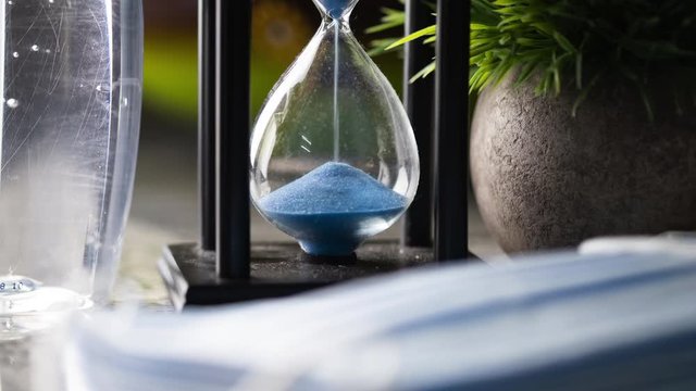 Conceptual time lapse of an hour glass on kitchen table.