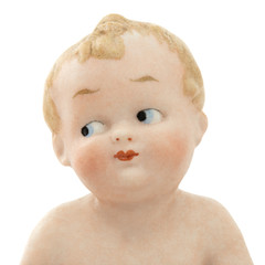 Face of vintage baby doll from ceramics closeup, isolated on white background