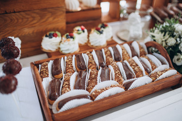 Sweet dessert table or candy bar. Wedding party. Natural light. Macaron and meringue pyramid. Cupcakes and marshmallow.