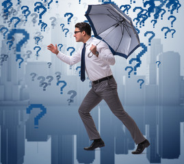 Uncertainty concept with businessman and question marks
