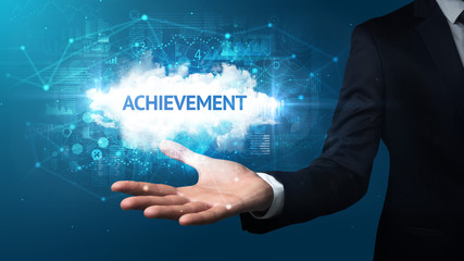 Hand of Businessman holding ACHIEVEMENT inscription, successful business concept