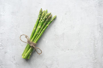 Bunch of fresh asparagus on concrete table. Top view. 
