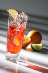 Fancy bar drink with fruit, liquor, and ice fixed by a bartender