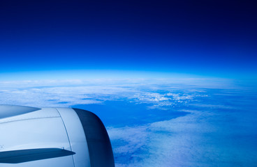 The view when looking out from the plane window that is on above the clouds
