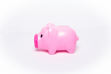 A pink piggy bank on the side of a white background