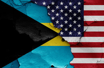 flags of Bahamas and USA painted on cracked wall