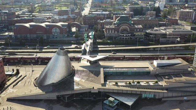 Aerial / drone footage of downtown Tacoma, Washington state during the COVID-19 outbreak, empty business district with tall office buildings.