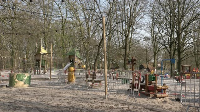 Wide shot of an empty playground, closed to keep social distance