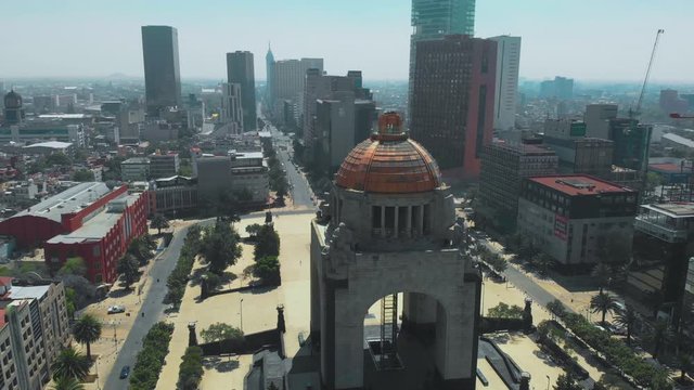 Panoramic aerial shot zoom out of the Monument to the Revolution, the Plaza de la Revolución and buildings in the background. During the covid-19 pandemic contingency in March 2020