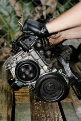 Hands working in a car engine. Cleaning a Car engine. Mechanical Workshop