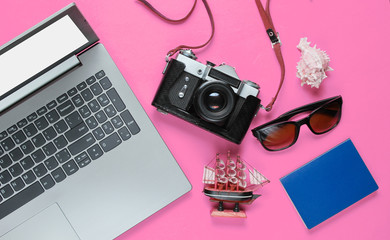Traveler accessories, retro camera on pink background. Trip on the beach, vacation. Summer minimalistic background. Flat lay tourism allegory..Top view