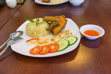 Plate of tasty deep-fried chicken wing and rice in restaurant