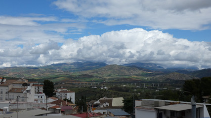 Large clouds over valley and high speed railway viaduct