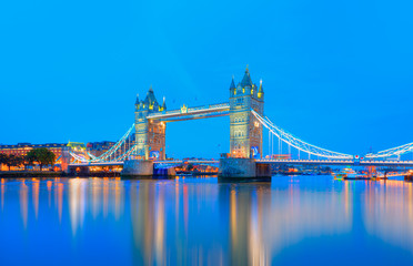 Panorama of the Tower Bridge and Tower of London on Thames river at twilight blue hour - London England