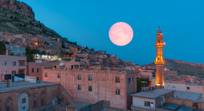 Sehidiye mosque with ful moon - Mardin old town at dusk. Historical beige colored limestone rock buildings "Elements of this image furnished by NASA "